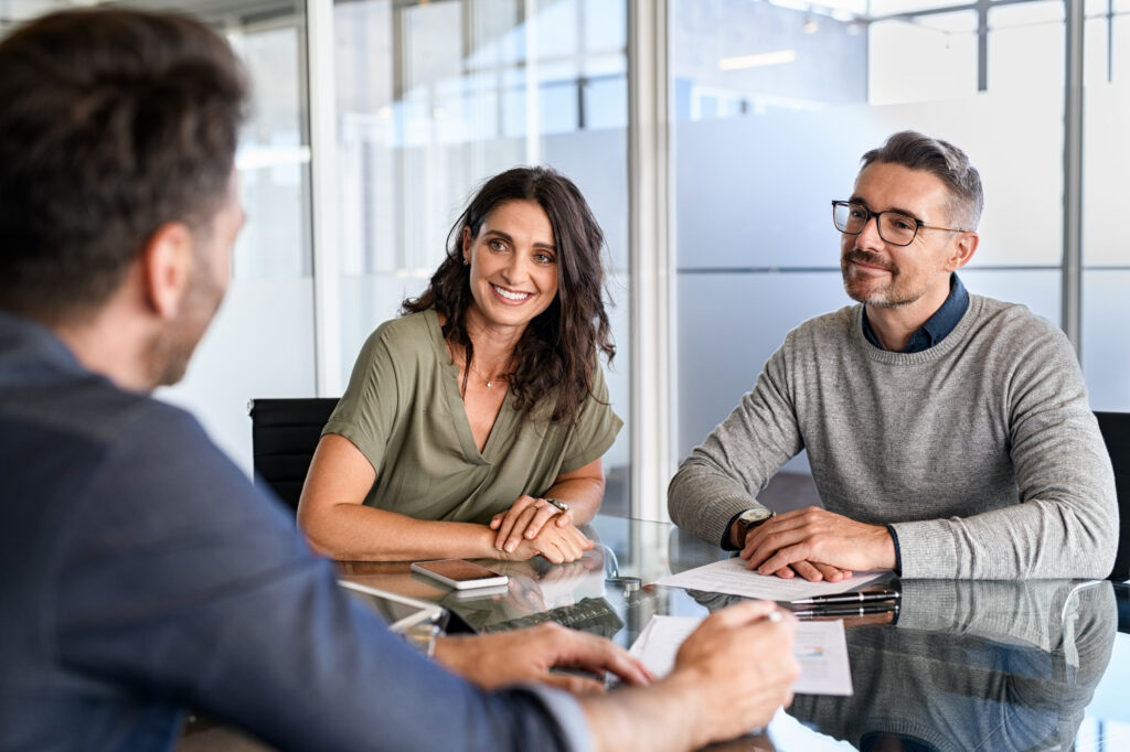 Business meeting with finance professionals discussing mortgage options, showcasing collaboration and decision-making in a modern office setting.