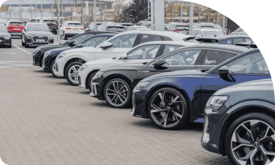 Row of various modern cars parked in a dealership lot, showcasing options for potential vehicle financing and car loans.